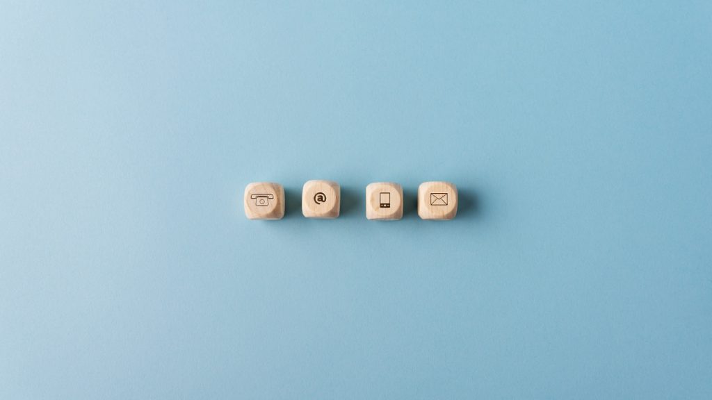 Contact and communication icons on wooden dices