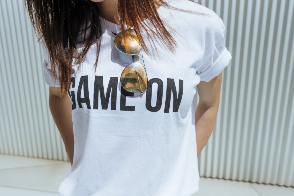 Crop woman in T-shirt with writing